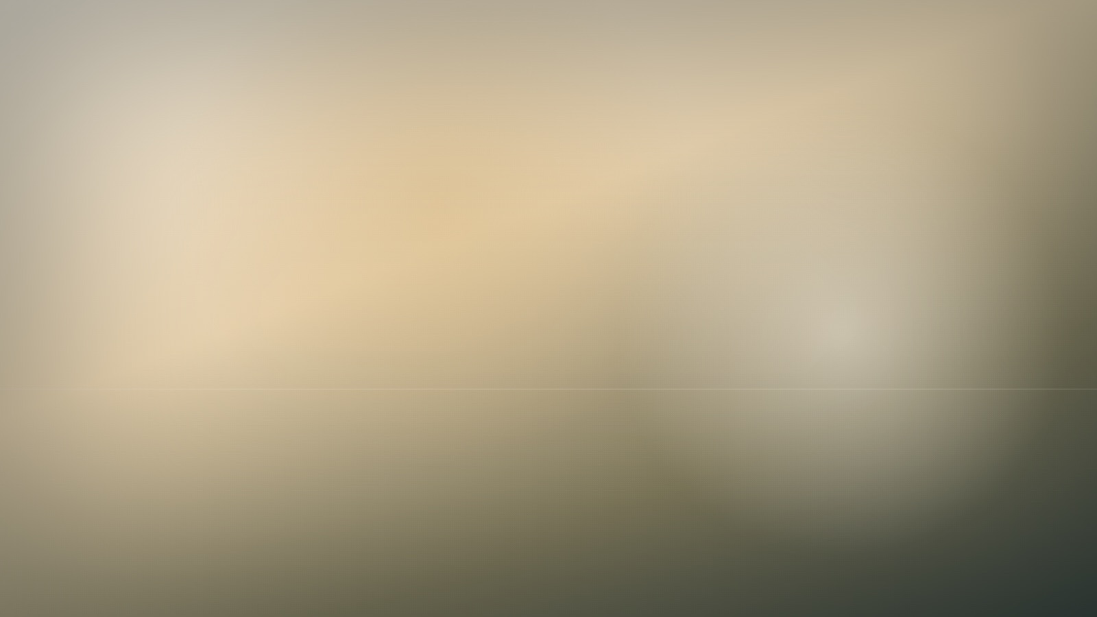 A broad expanse of soft, even colour beneath a still and quiet sky.